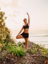 Attractive yoga woman practice at beach with sunset or sunrise