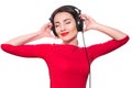 Attractive young adult woman in red clothes listening to the mus Royalty Free Stock Photo