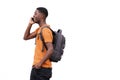 Attractive young african american man walking and talking on mobile phone by white background Royalty Free Stock Photo