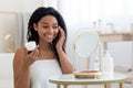 Attractive Young African American Woman Applying Moisturising Cream On Face Royalty Free Stock Photo