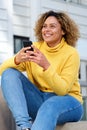 Attractive young african american woman holding mobile in city Royalty Free Stock Photo