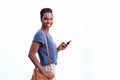 Attractive young african american woman smiling with cellphone against isolated white background Royalty Free Stock Photo