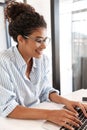 Attractive young african woman working on laptop computer Royalty Free Stock Photo