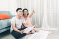 Attractive young asian adult couple looking at house plans. Royalty Free Stock Photo