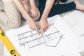 Attractive young asian adult couple looking at house plans. Royalty Free Stock Photo