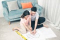 Attractive young asian adult couple looking at house plans. Royalty Free Stock Photo