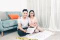 Attractive young asian adult couple looking at house plans. Royalty Free Stock Photo