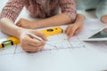 Attractive young asian adult couple looking at house plans. Royalty Free Stock Photo