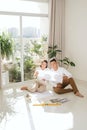 Attractive young asian adult couple looking at house plans Royalty Free Stock Photo
