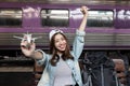 Attractive young Asian backpacker woman having fun at train station. Ready for travel Royalty Free Stock Photo