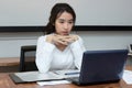 Attractive young Asian business woman working on laptop computer in office. Royalty Free Stock Photo