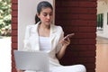 Attractive young Asian business woman working with laptop and mobile smart phone at outside office Royalty Free Stock Photo