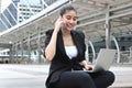 Attractive young Asian business woman working with laptop and mobile smart phone at outside office Royalty Free Stock Photo