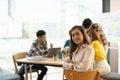 Attractive young Asian business woman smiling and looking over shoulders at business meeting with co-workers Royalty Free Stock Photo