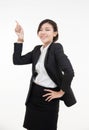 Attractive young asian businesswoman looking at camera, showing finger up at workplace,likes her job, acceptance approval sign,