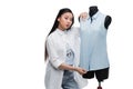 Attractive young asian fashion designer posing with blouse on dummy