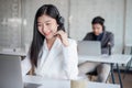 Attractive young asian female call center agent in headset consulting client. Customer service team support concept Royalty Free Stock Photo