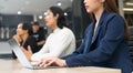 The attractive young Asian girl working on a laptop with group of diverse employees business people team during a brainstorming Royalty Free Stock Photo