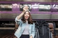 Attractive young Asian lady tourist with model airplane at train station. Travel lifestyle concept Royalty Free Stock Photo