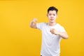 Attractive young asian man hold fist fury and angry negative emotion wearing white t-shirt Royalty Free Stock Photo