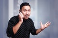 Young Man Getting Bad News on Phone, Shocked and Angry Royalty Free Stock Photo