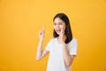 Attractive young asian woman announcing with hands to the mouth  and telling a secret, isolated on light orange background. Royalty Free Stock Photo