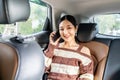 Attractive Young Asian Woman in Car Using Mobile Phone. Teenage Female Sitting on Backseat and Talking on Smartphone Royalty Free Stock Photo