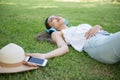 Asian woman listen online music in park Royalty Free Stock Photo