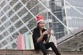 Attractive young Asian woman with santa hat and colorful shopping bag using mobile smart phone for shopping online for christmas g Royalty Free Stock Photo
