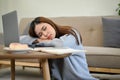 Attractive young Asian woman sleeping, leaning on a table, fall asleep in the living room Royalty Free Stock Photo