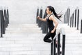 Attractive young asian woman in sportswear jogging on stadium stairs Royalty Free Stock Photo