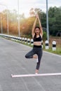 Attractive young asian woman standing in yoga pose. Practicing yoga. Royalty Free Stock Photo