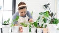 Attractive Young Asian woman taking care Water the household plants pots near window, Gardening at Home concept Royalty Free Stock Photo