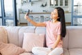 An attractive young asian woman is taking a selfie with a smartphone Royalty Free Stock Photo