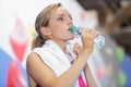 attractive young athlete drinking water in gym Royalty Free Stock Photo