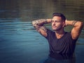 Young man standing in water in sea or lake Royalty Free Stock Photo