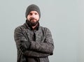 Attractive young bearded man keeping arms crossed and smiling Royalty Free Stock Photo