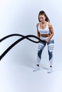 An attractive young beaut ful athletic girl using training ropes at gym Royalty Free Stock Photo