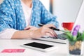 Attractive Young beautiful entrepreneur Woman smiling and looking at laptop screen, Working from Home Royalty Free Stock Photo