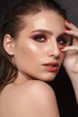 Attractive young beauty model with professional make up, perfect skin and nude lips. Trendy colorful smoky eyes Royalty Free Stock Photo