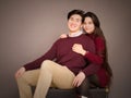 Attractive young biracial couple in burgundy colored sweaters posing