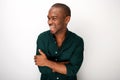 Attractive young black man smiling against white background with arms crossed Royalty Free Stock Photo
