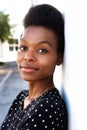 Attractive young black woman standing by a wall Royalty Free Stock Photo