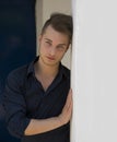 Attractive young blond man leaning against wall Royalty Free Stock Photo