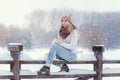 Attractive young blonde girl walking in winter forest. Pretty woman in wintertime outdoor. Wearing winter clothes. Knitted sweater Royalty Free Stock Photo