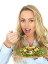 Attractive Young Blonde Haired Woman Eating a Fresh and Healthy Prawn Salad Royalty Free Stock Photo