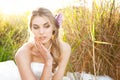 Attractive Young Bride Sitting in the Grass Royalty Free Stock Photo