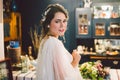 Attractive young bride before wedding ceremony. Bride`s Preparations. Wedding Morning. Charming bride in white wedding dress at