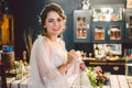 Attractive young bride before wedding ceremony. Bride`s Preparations. Wedding Morning. Charming bride in white wedding dress at