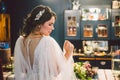 Attractive young bride before wedding ceremony. Bride`s Preparations. Wedding Morning. Charming bride in white wedding dress at